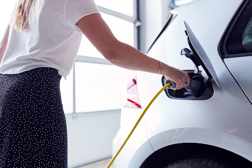 Homeowner plugging electric car into EV charger station